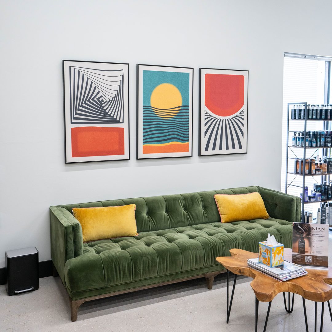 The lounge at Salon 80 West: green velvet sofa and mid-century art